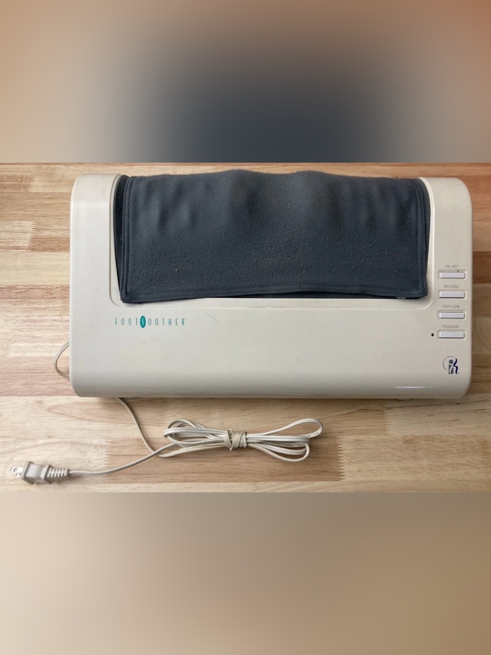 E1 FootSoother Electric Foot Massager in Beige with Black Pad
